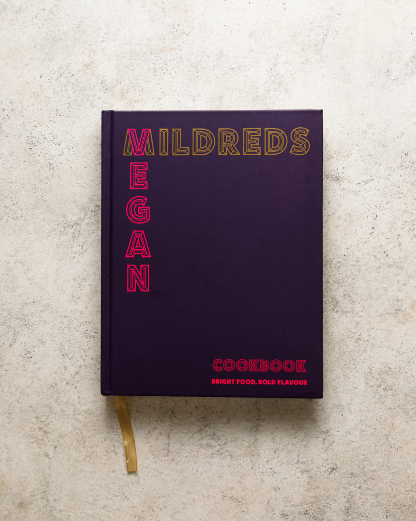 Mildreds Vegan cookbook on a beige textured backdrop