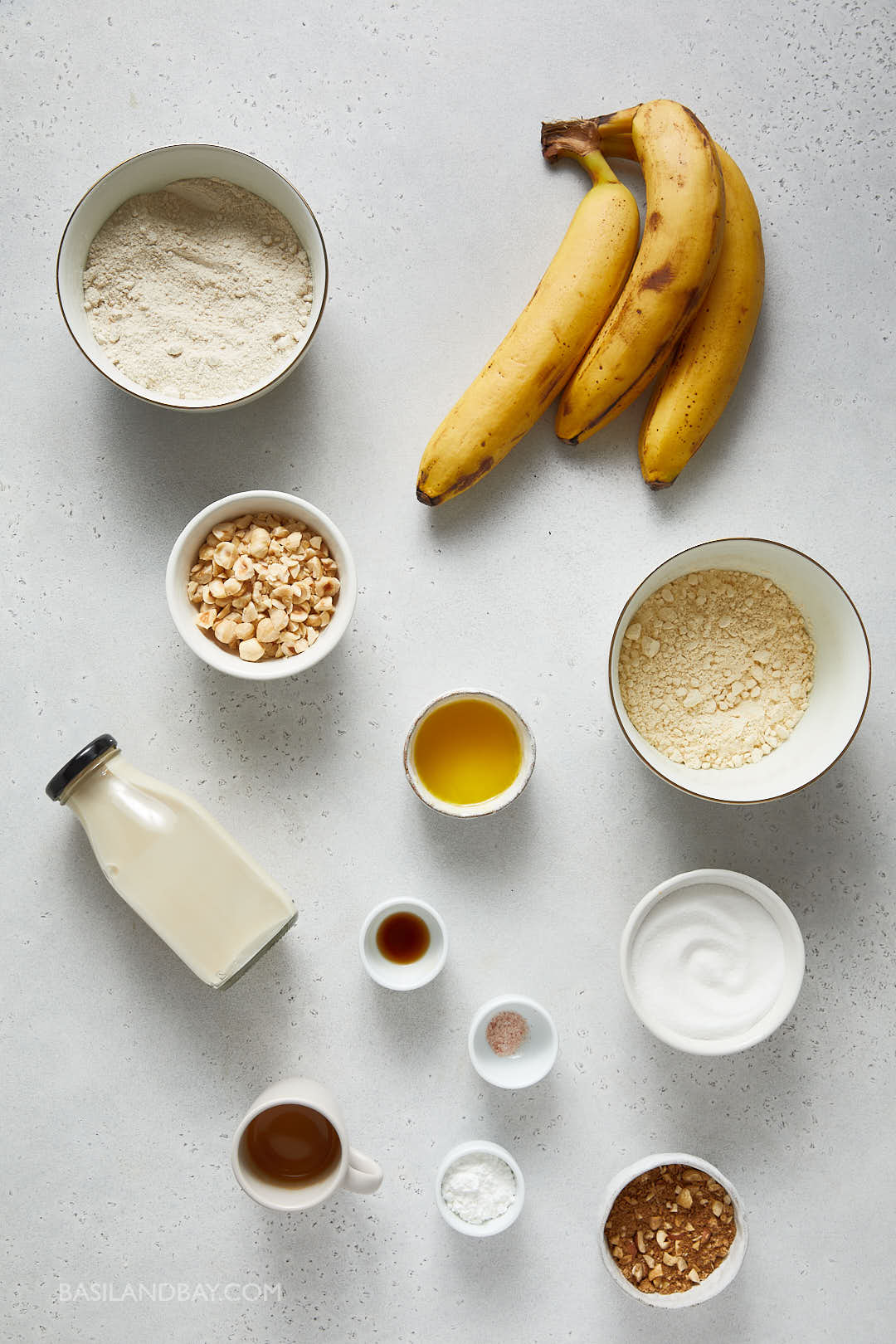 ingredients for banana espresso muffins laid out as a flat lay on a cream speckled background