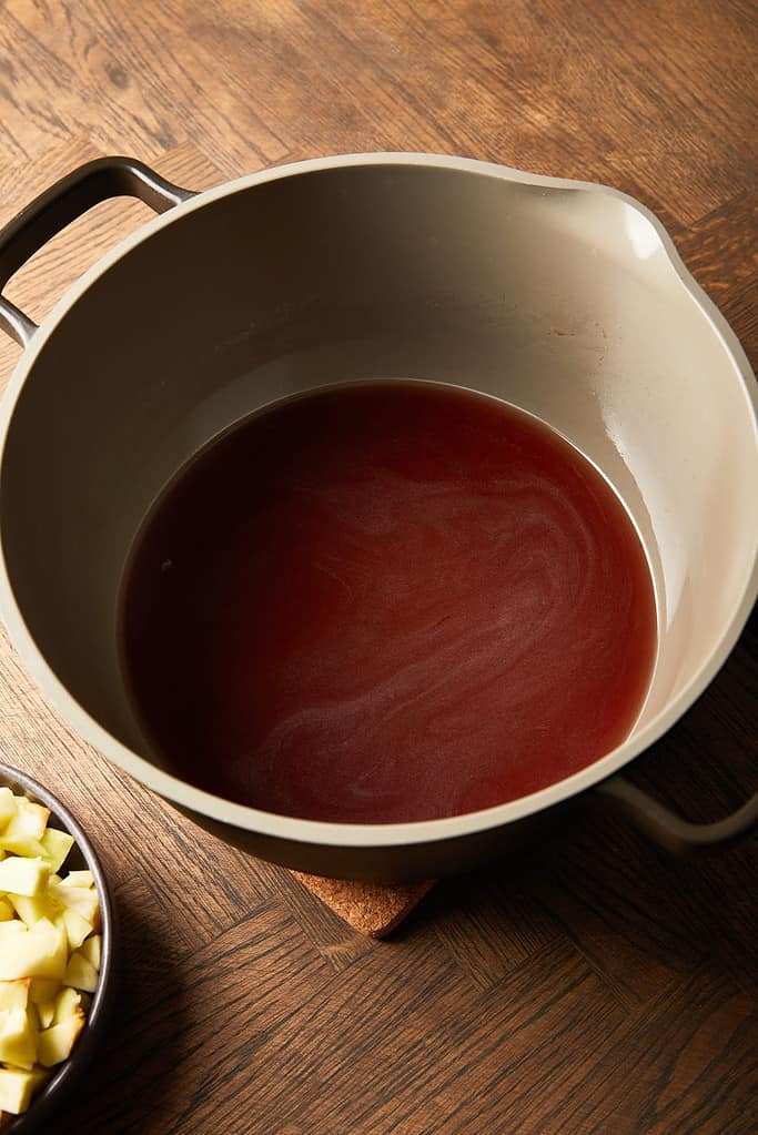 Image of red wine vinegar and sugar mixture in a large saucepan