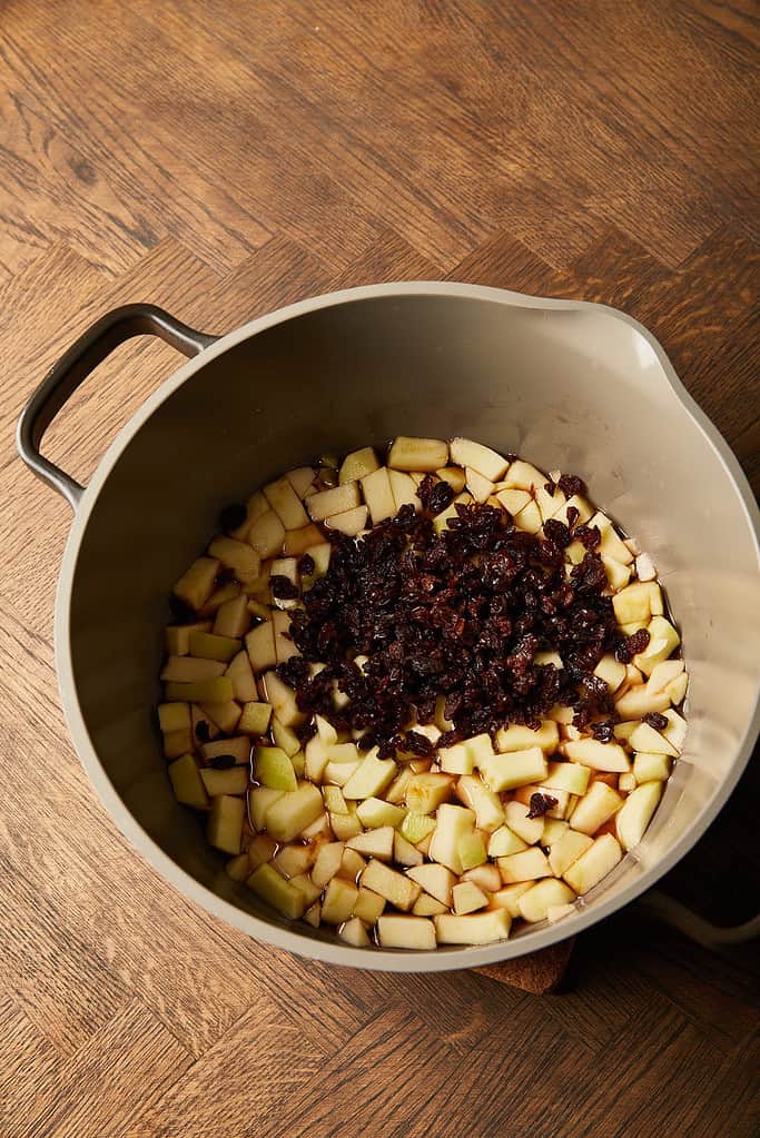 Image of apples and raisins  mixture in a large saucepan