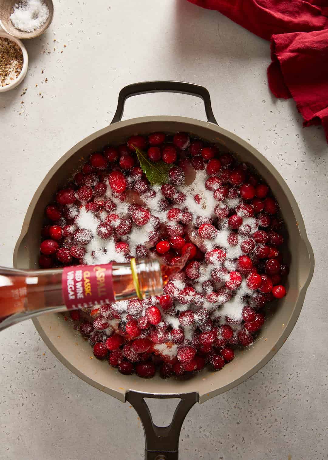cranberry sweet chilli jam aspall red wine vinegar being added into the  pan