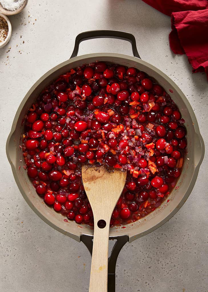 cranberry sweet chilli jam cranberries being stirred in the  pan