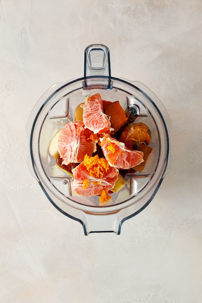 overhead shot of Sweet Potato & Cranberry Smoothie ingredients in a vitamix blender jug