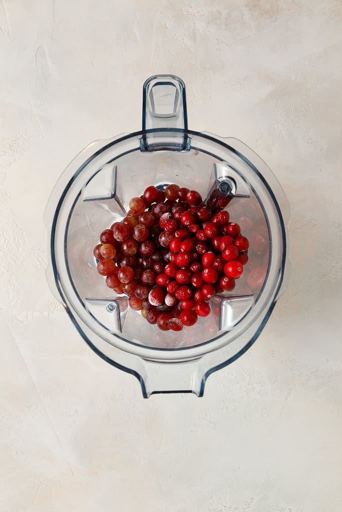 overhead shot of Sweet Potato & Cranberry Smoothie ingredients in a vitamix blender jug