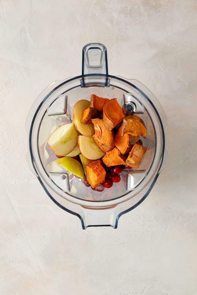 overhead shot of Sweet Potato & Cranberry Smoothie ingredients in a vitamix blender jug