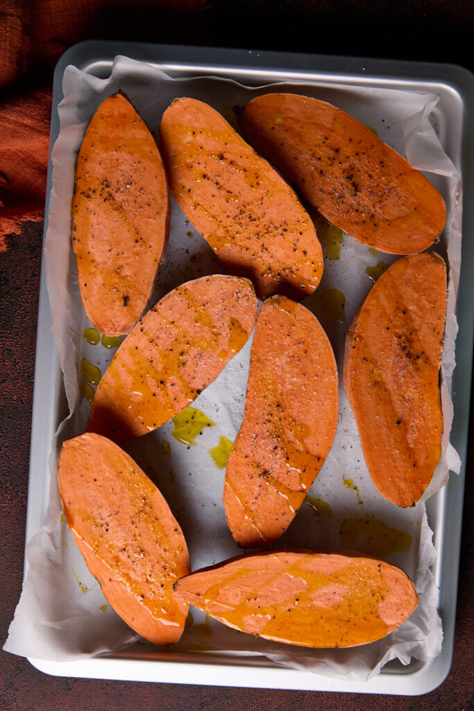 sweet potatoes  cut side up drizzled with olive oil and seasoned with salt and pepper