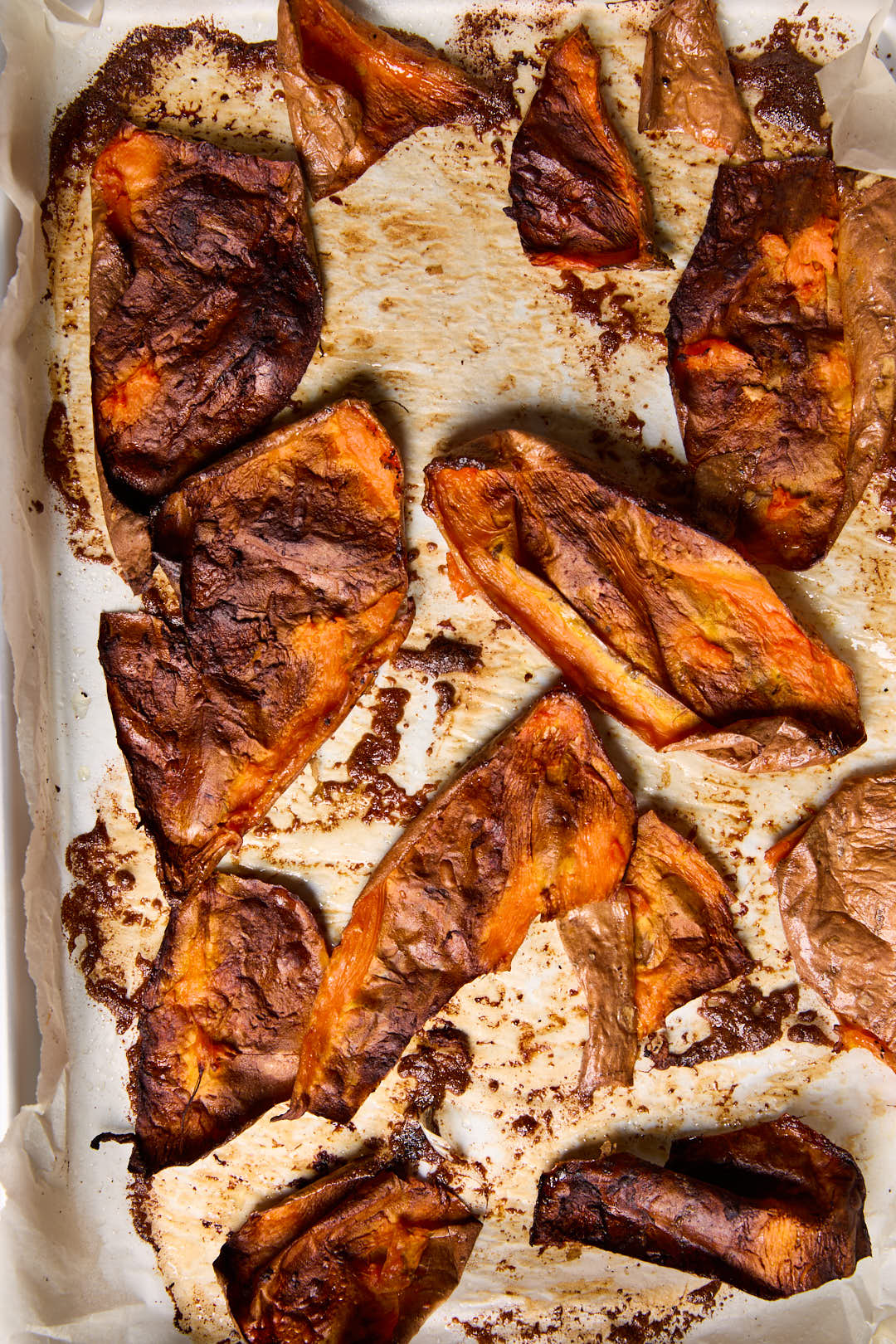 Crispy sweet potato skins on a lined baking sheet