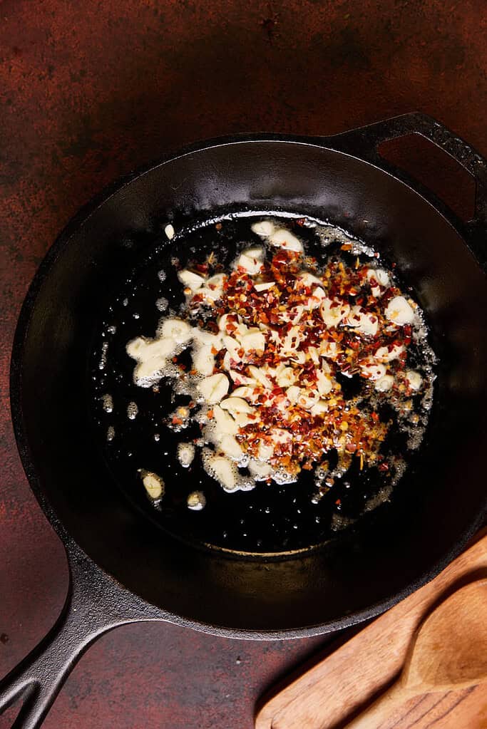 garlic and red pepper flakes in a cast iron pan 