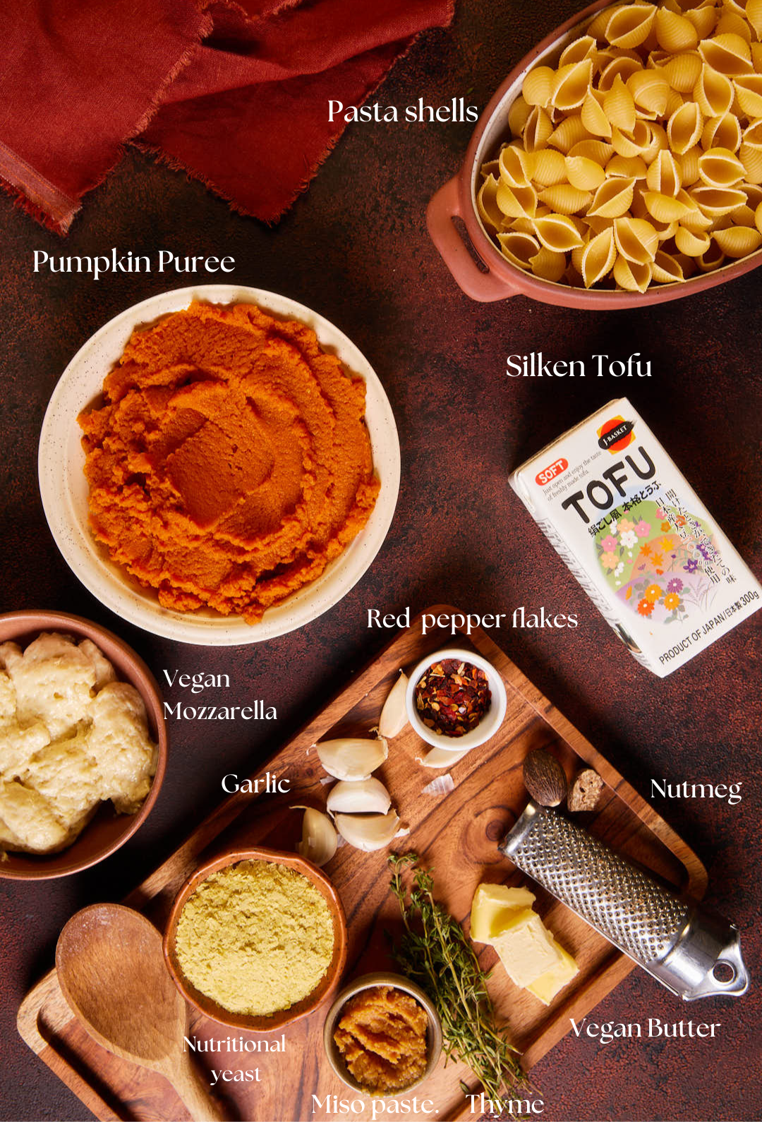 Flat lay image with all the ingredients needed for pumpkin mac and cheese laid out and labelled