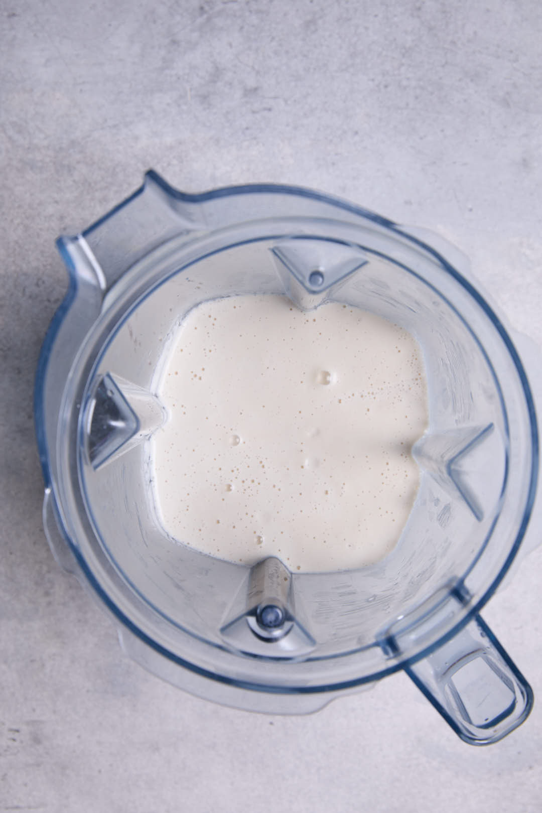 blended cashew sour cream in a blender jug