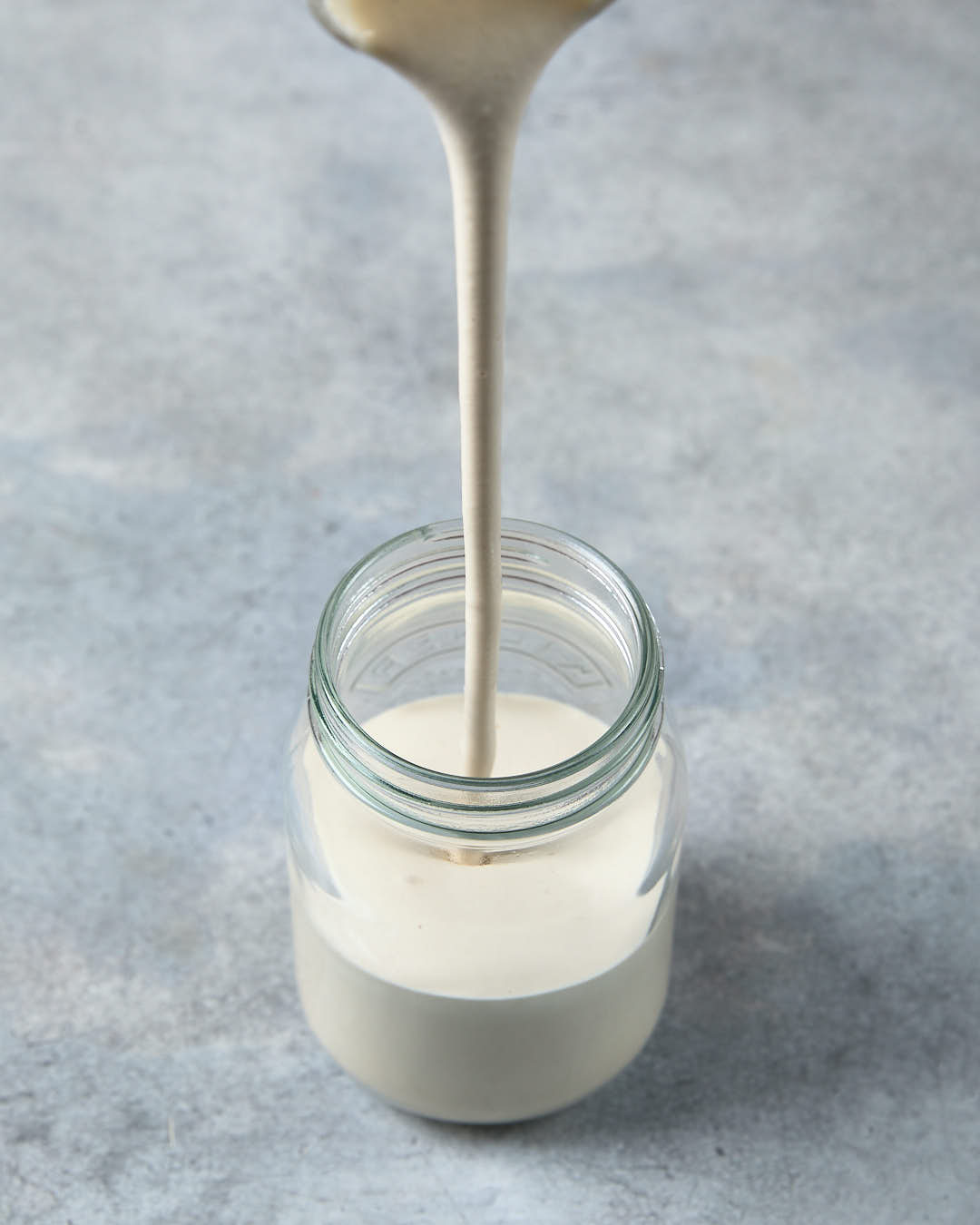 Picture of Dairy-Free Vegan Sour Cream being poured into a jar.