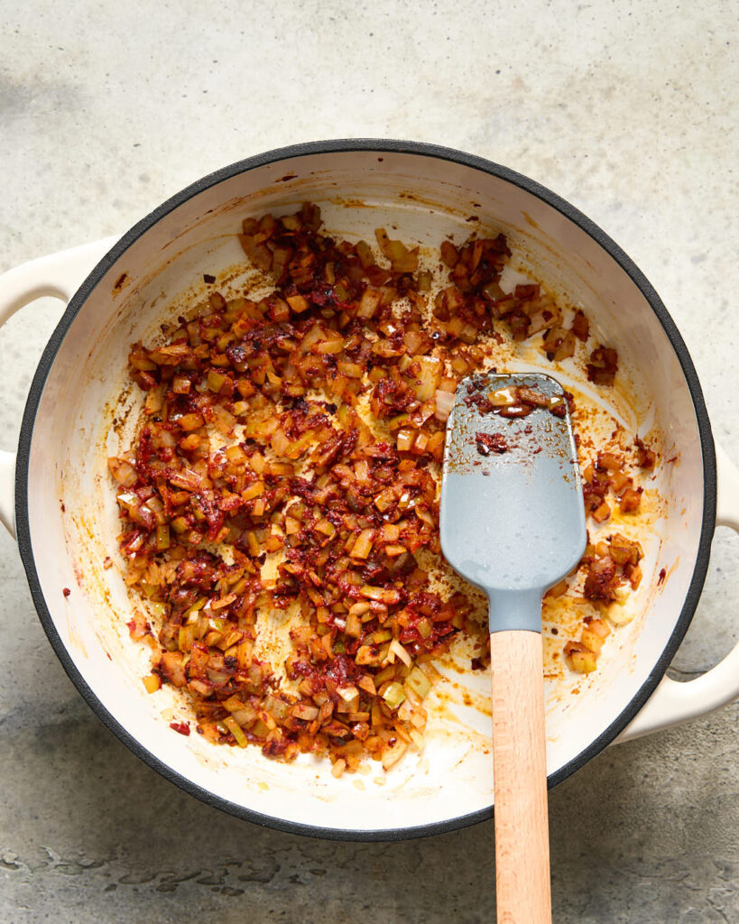 Onion and sauce ingredients sautéing for Vegan Roasted Red Pepper pasta