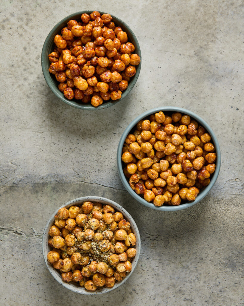 Three bowls of crispy chickpeas seasoned with BBQ, sweet chilli, and za’atar spice.