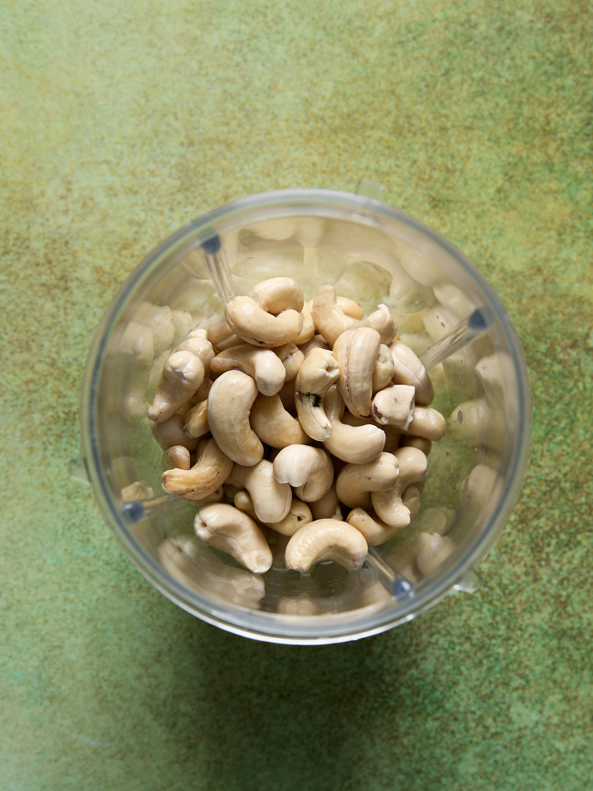 bowl of raw cashews soaking in water.