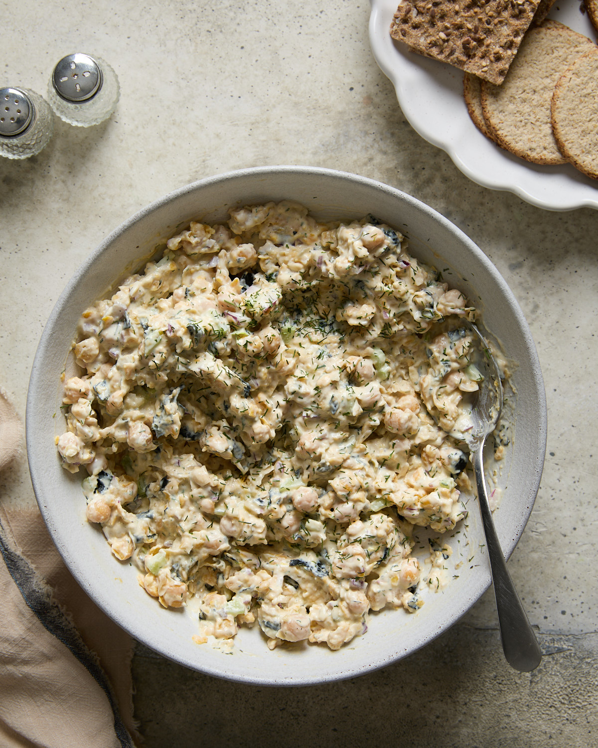 Finished vegan chickpea tuna salad with dill, capers, and creamy dressing in a bowl